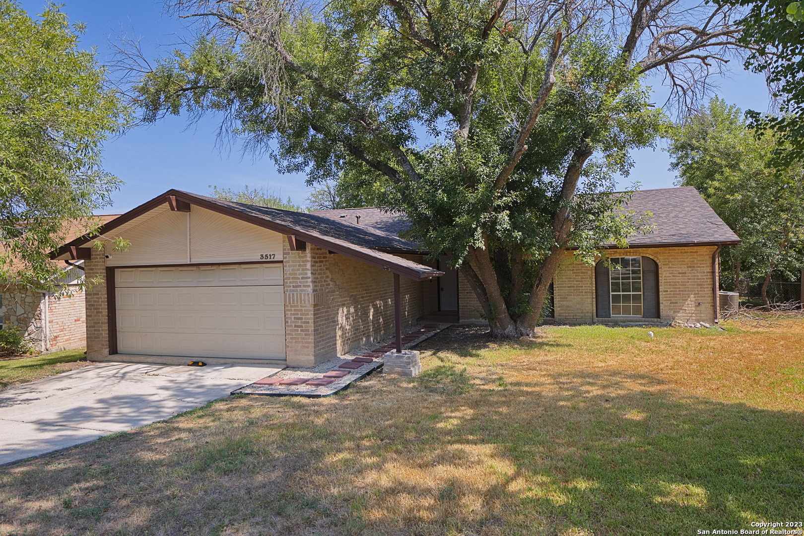 a front view of house with yard and trees