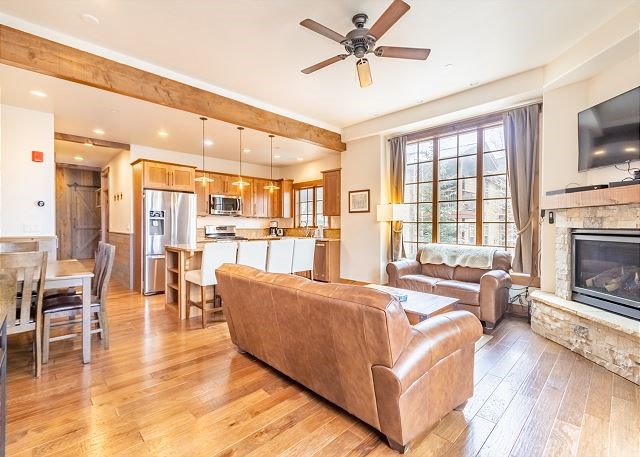 a living room with furniture a fireplace and a flat screen tv