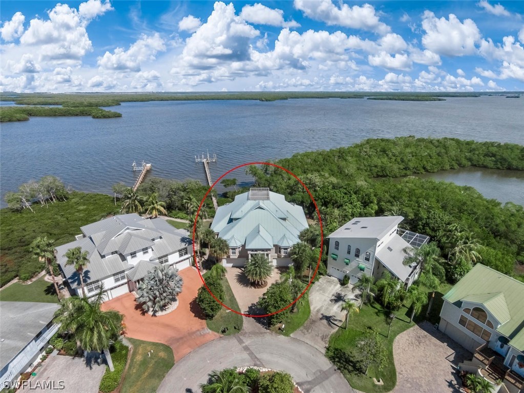 an aerial view of a house with a lake view