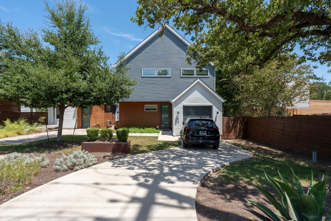 a front view of a house with a garden