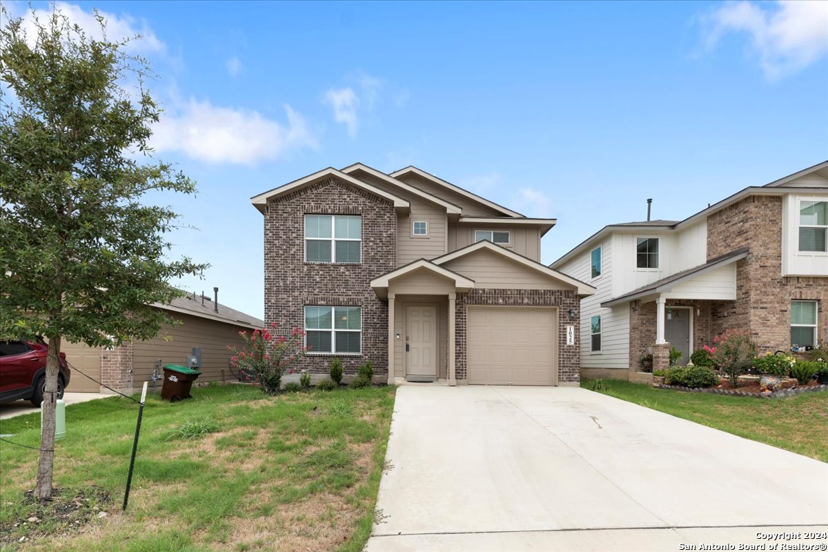 a front view of a house with a yard