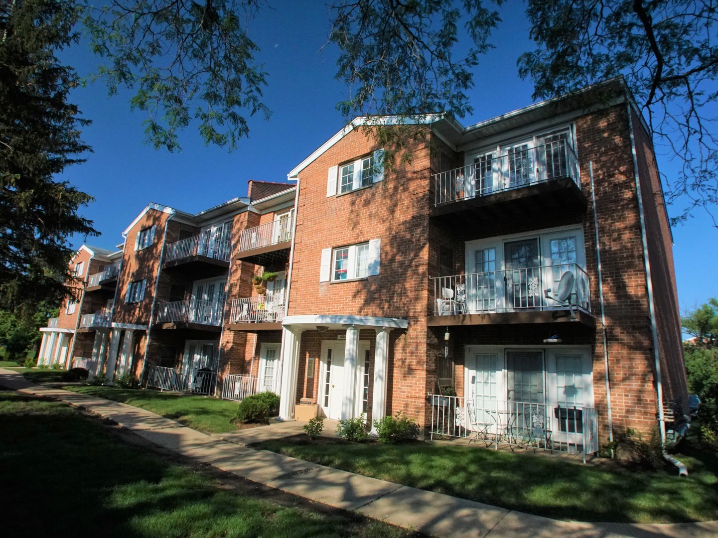 a front view of a building with a garden