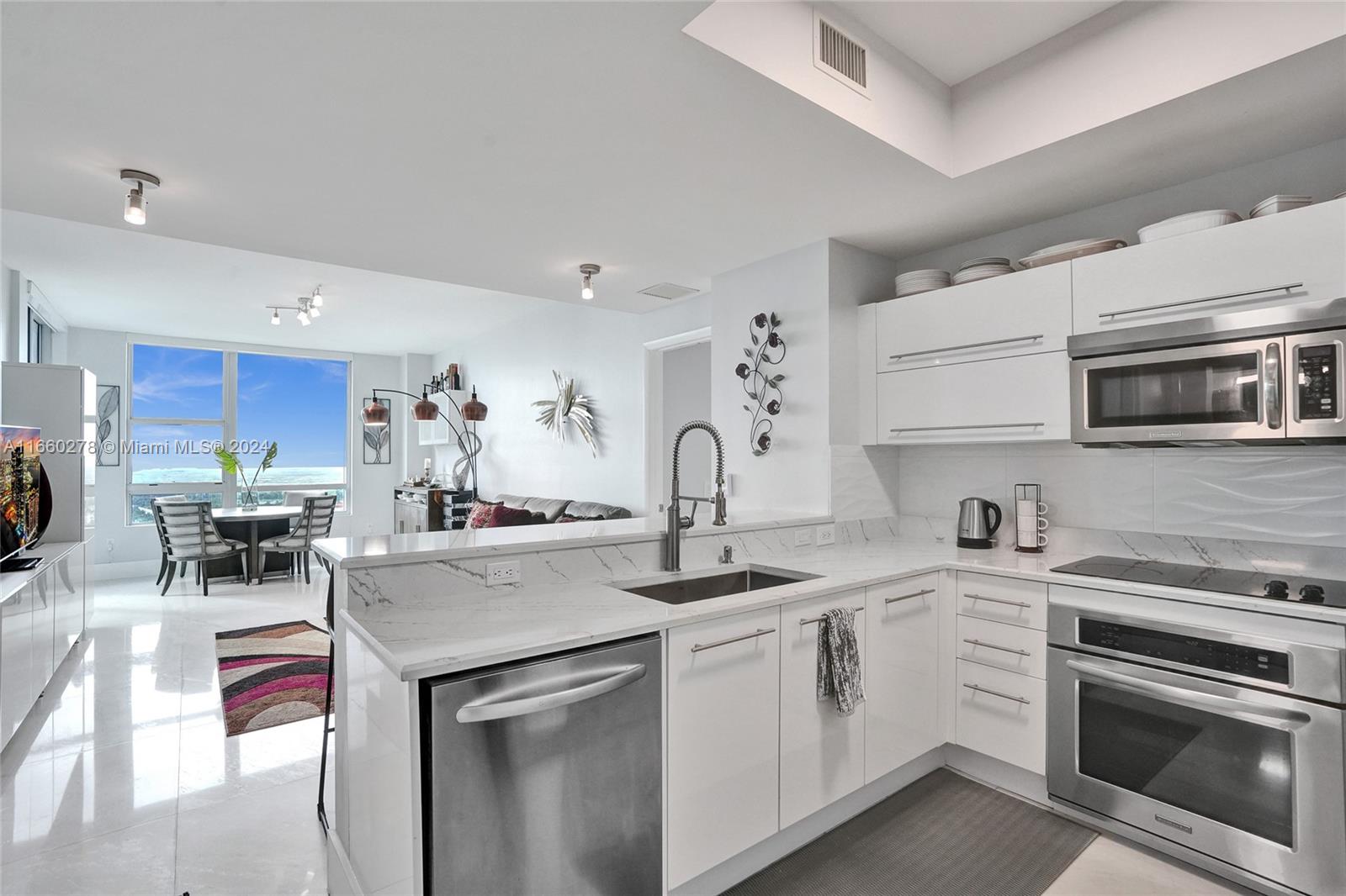 a kitchen with stainless steel appliances granite countertop a stove and cabinets