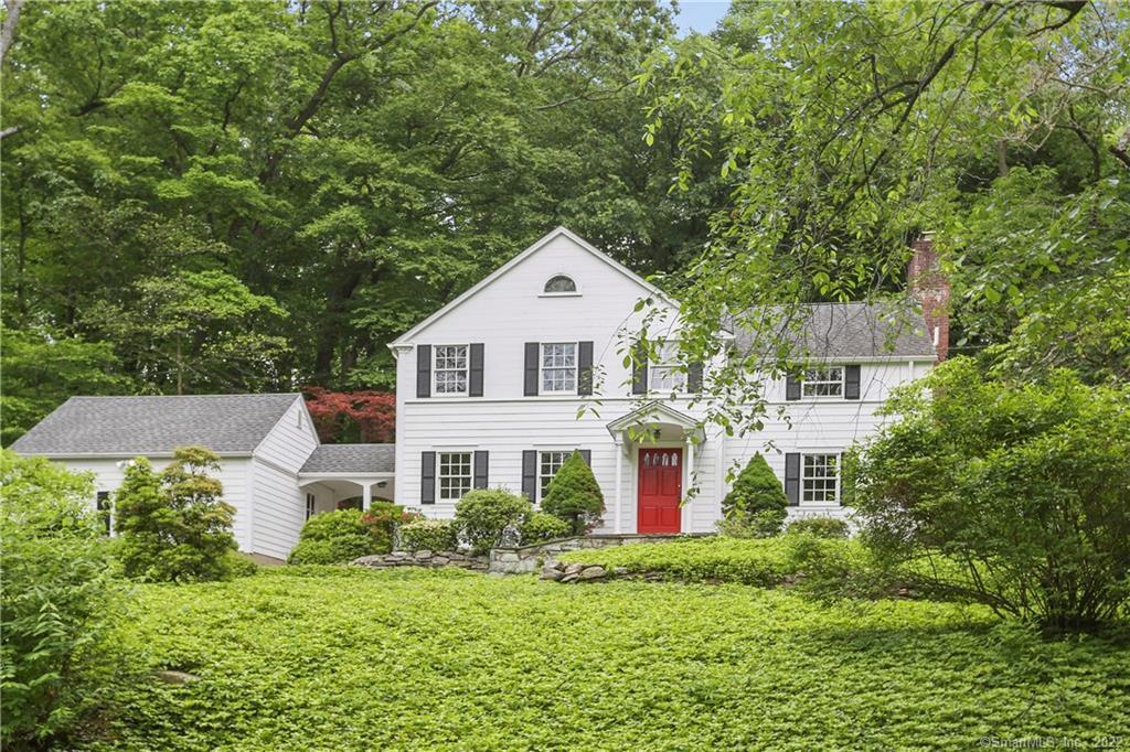 a view of a house with a yard and potted plants