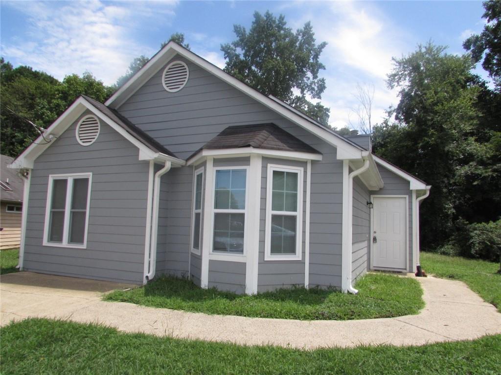 a front view of a house with a yard