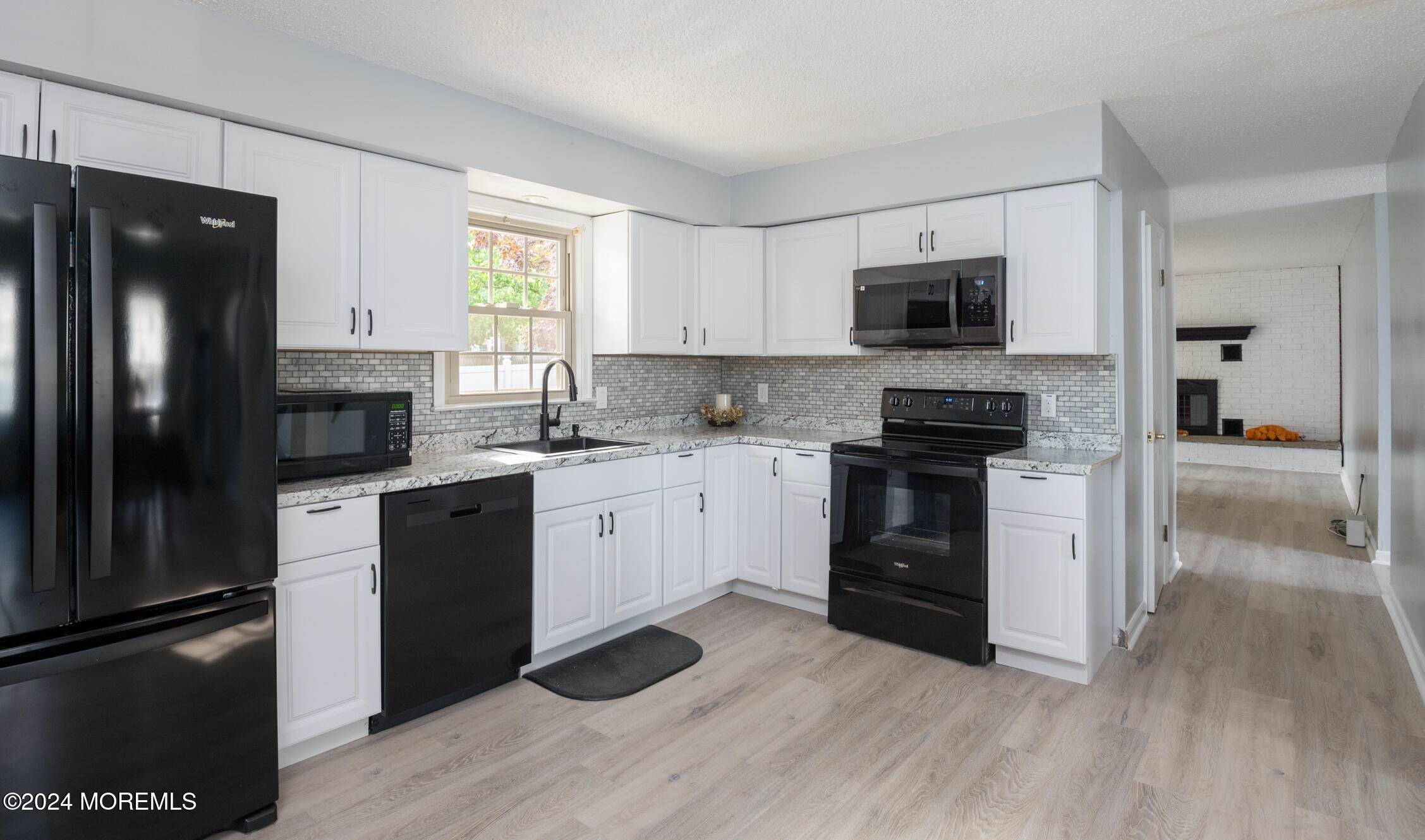 a kitchen with a refrigerator stove and sink