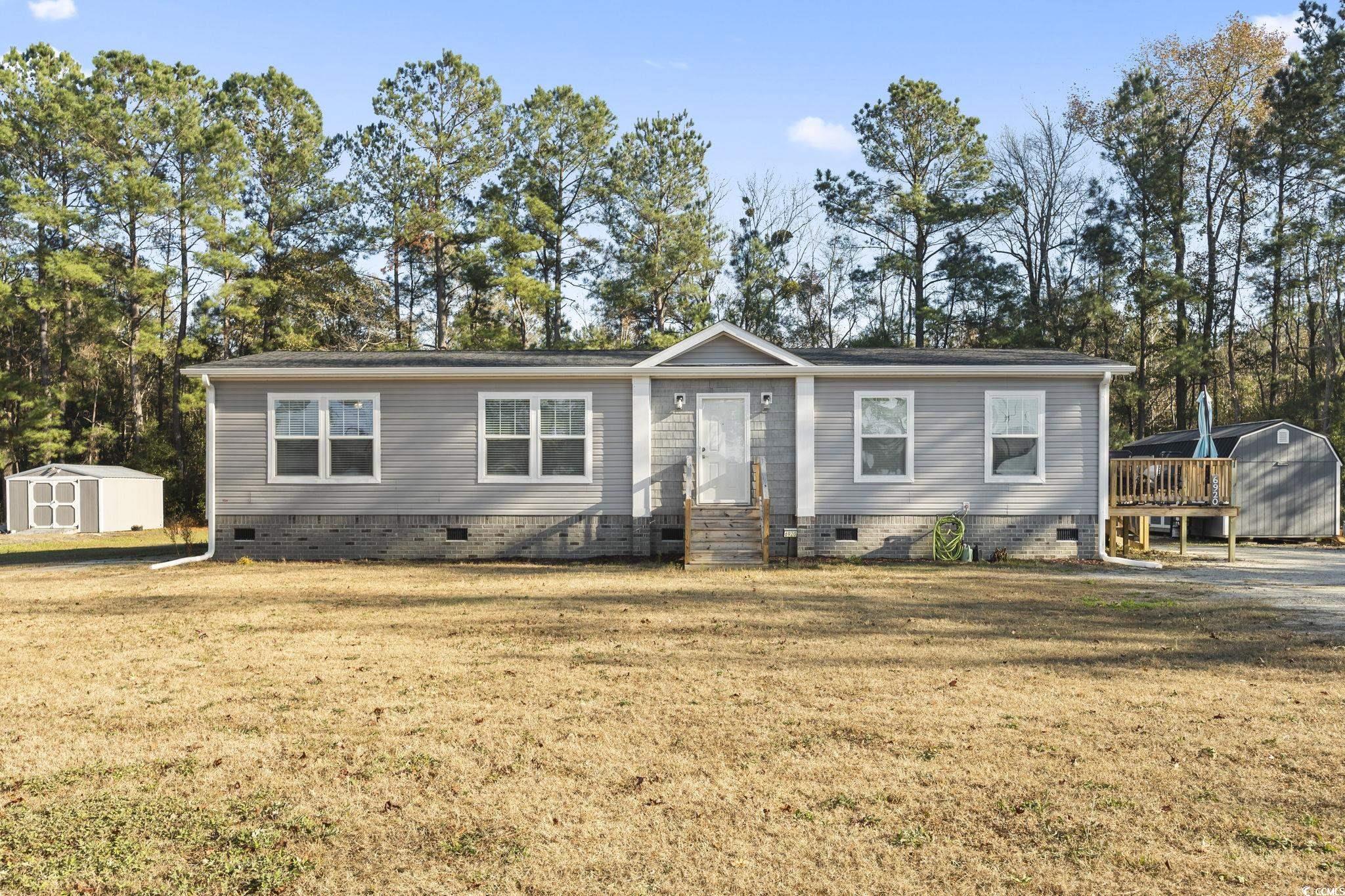 View of front of home featuring a storage shed and