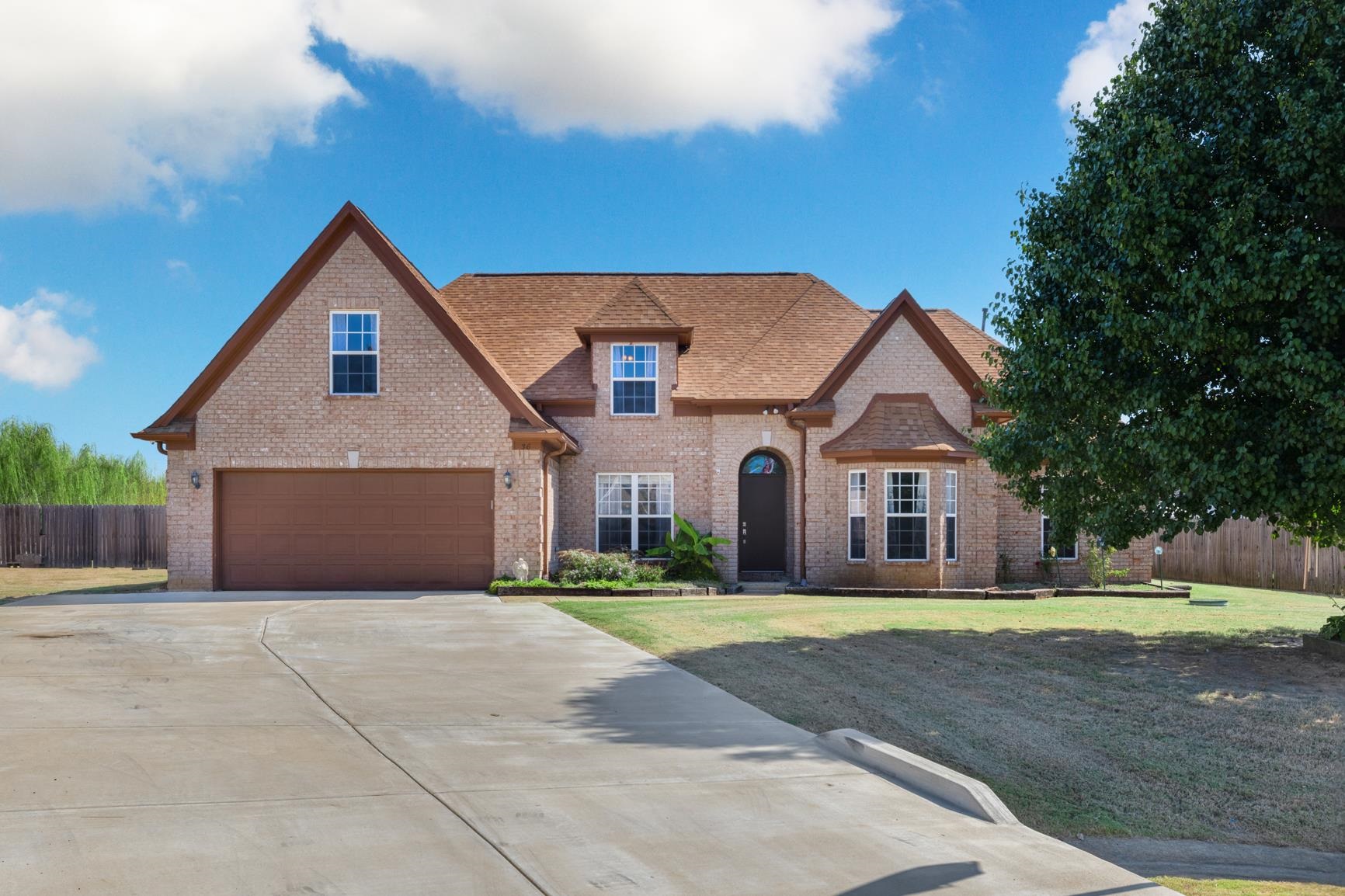 a front view of a house with a yard and garage