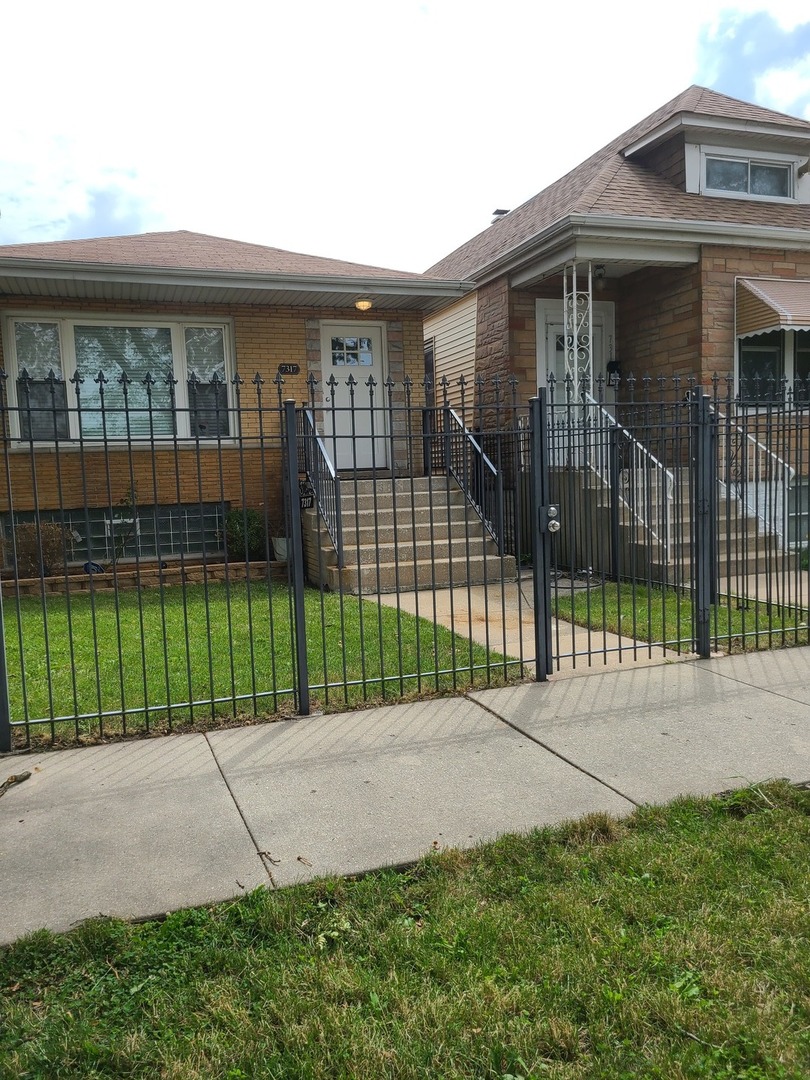 a view of a house with a backyard and a garden