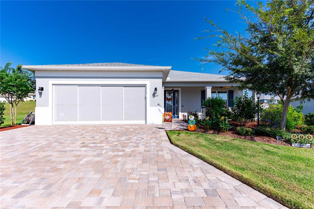 a view of a house with backyard and porch