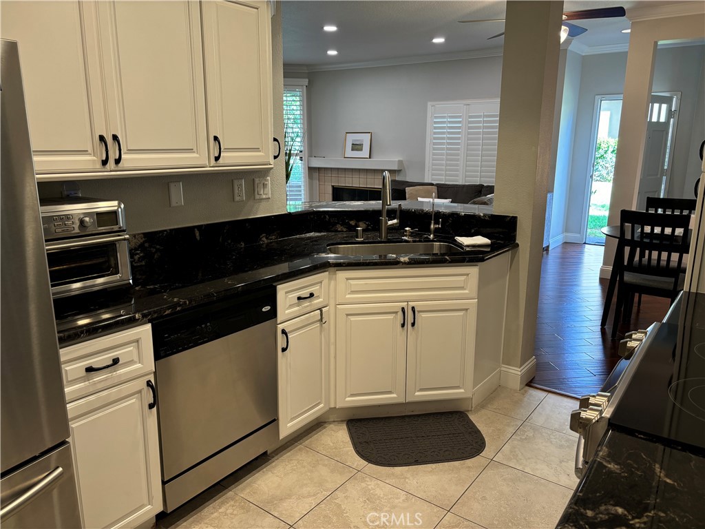 a kitchen with granite countertop a sink and a stove