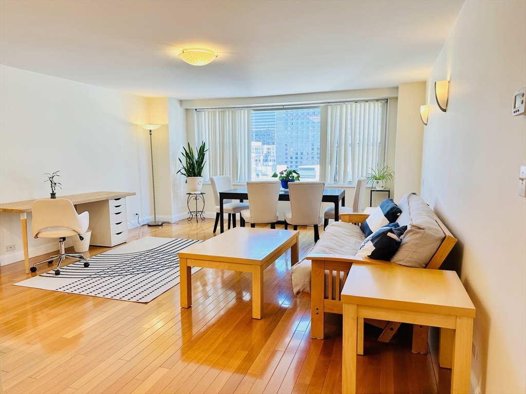 a view of a dining room with furniture window and wooden floor