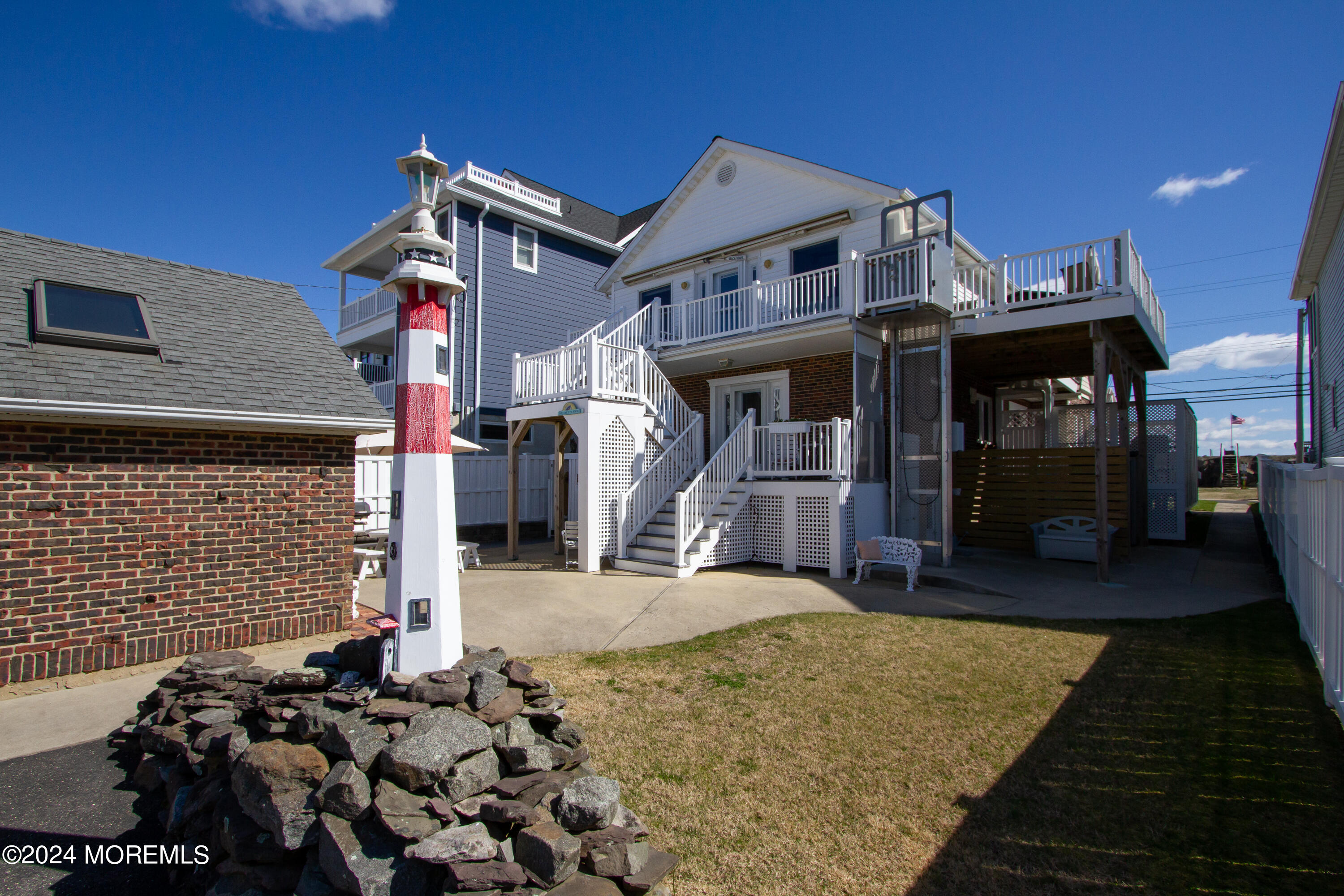 a front view of a house with a large tree