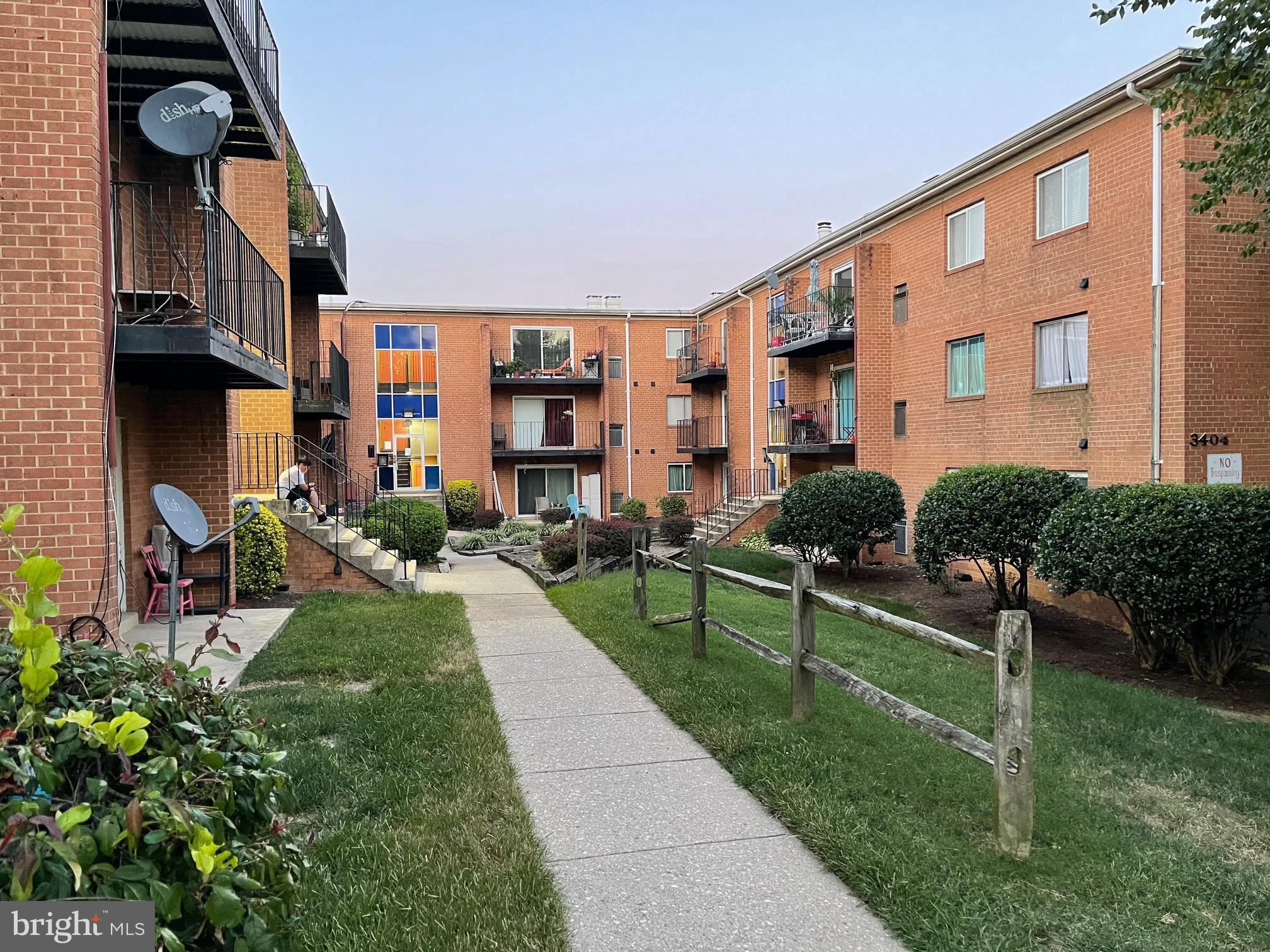 a front view of multiple houses with yard