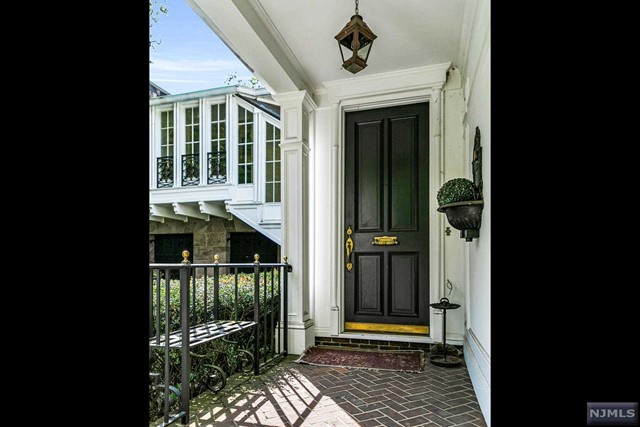 a porch with a door and balcony