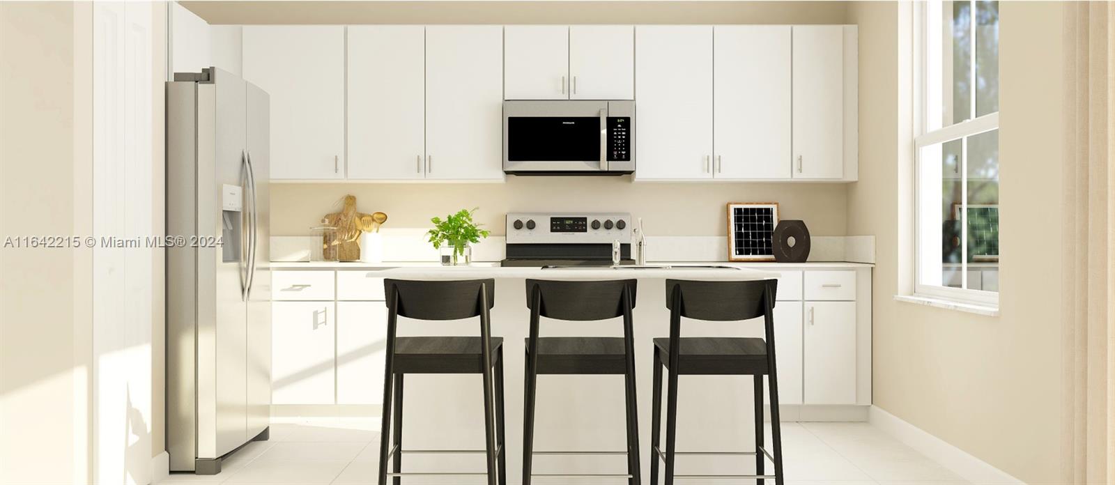 a kitchen with stainless steel appliances kitchen island granite countertop white cabinets and chairs