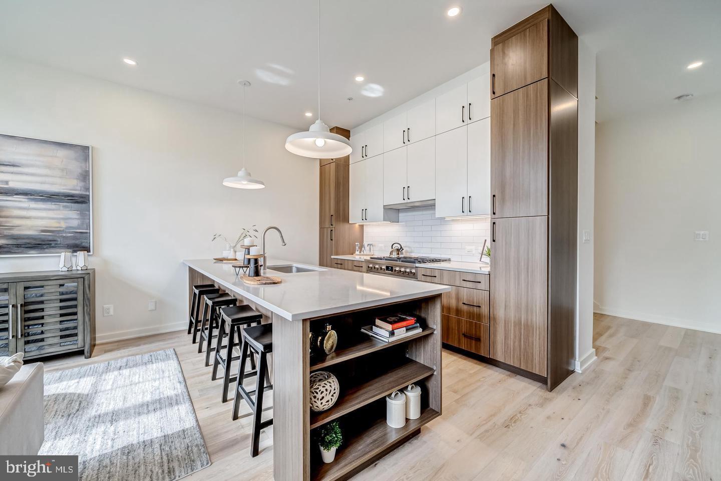 a kitchen with kitchen island a sink stove and refrigerator