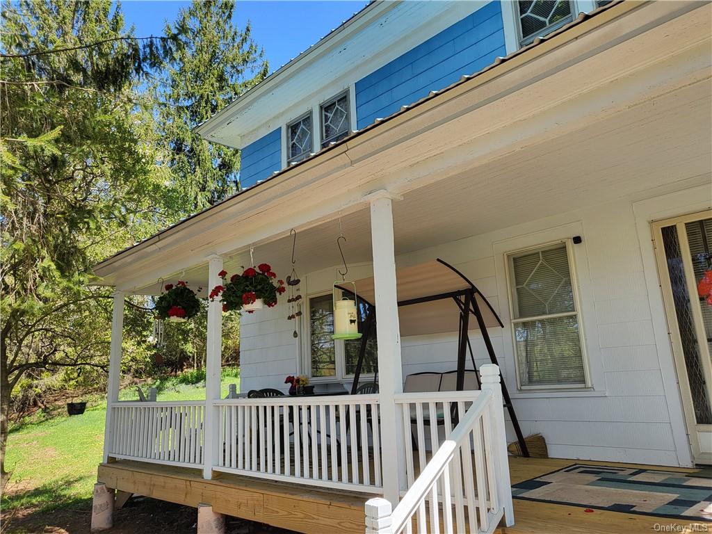 a view of balcony with deck and furniture