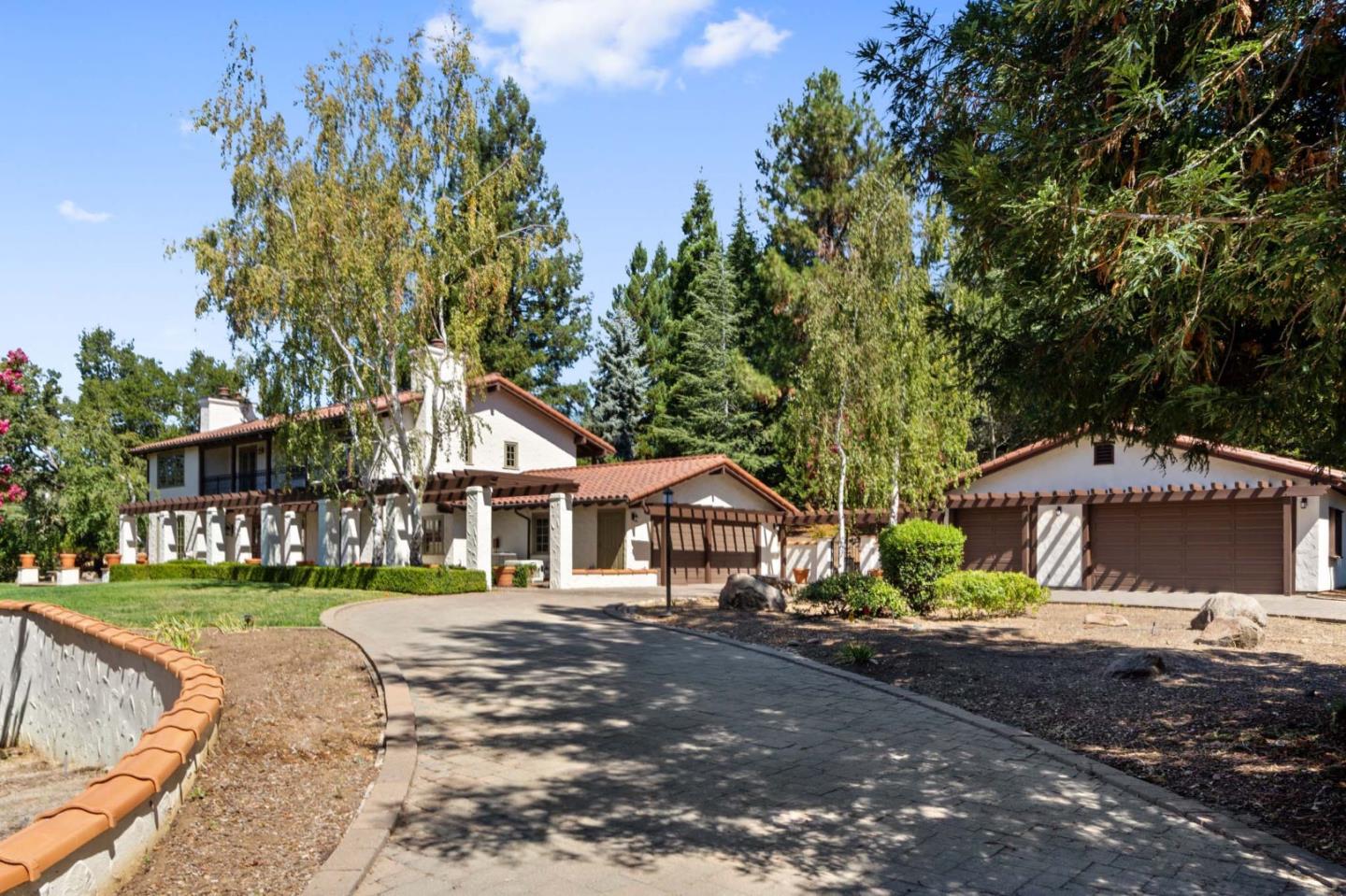 a front view of a house with a yard and a garage