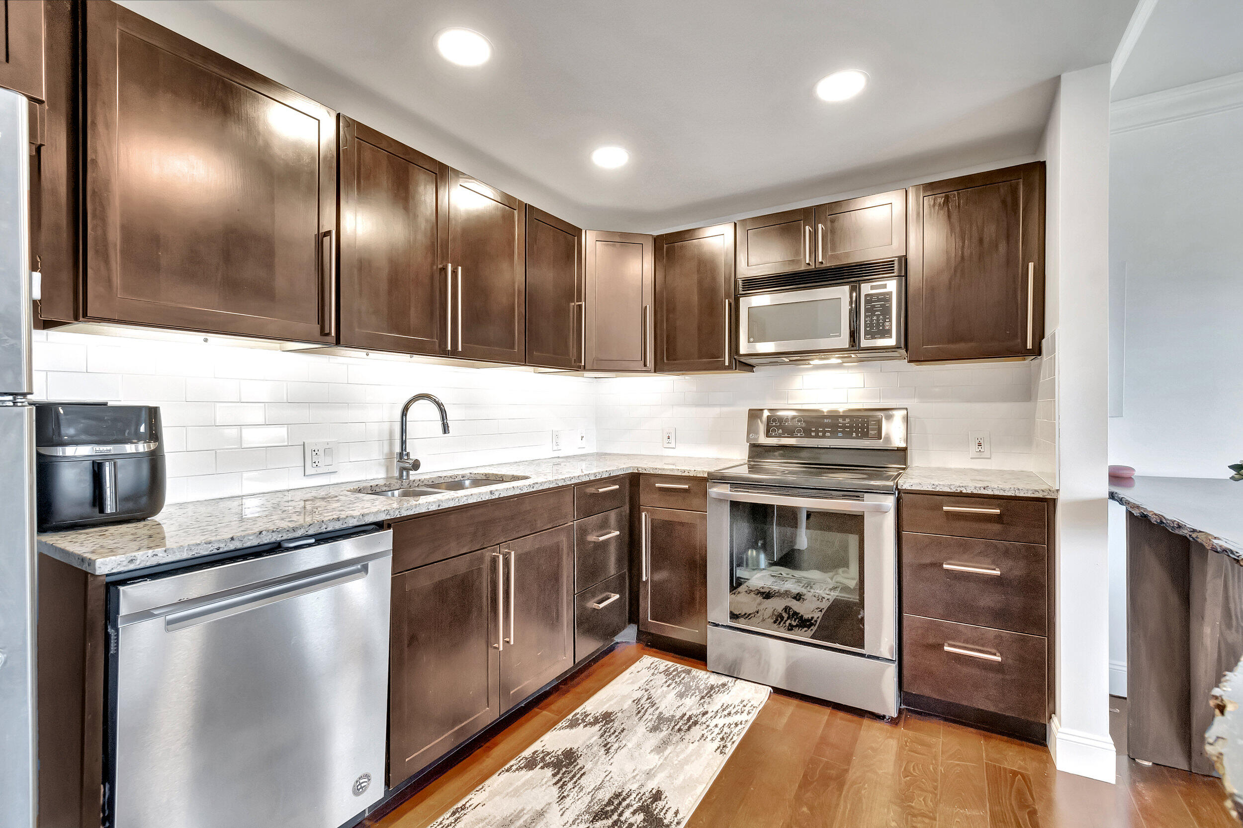 a kitchen with stainless steel appliances granite countertop a sink and stove top oven