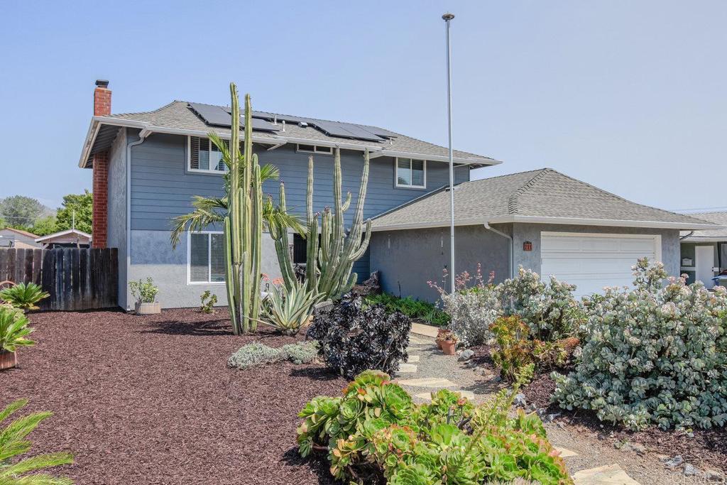 a view of a house with a yard and plants