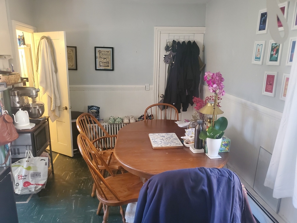 a dining room with furniture and wooden floor