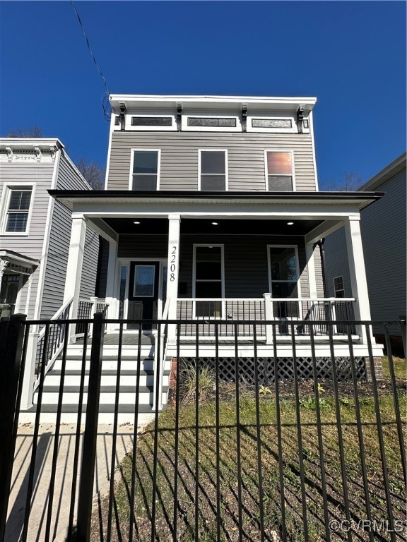 View of front of house with a porch and a front la