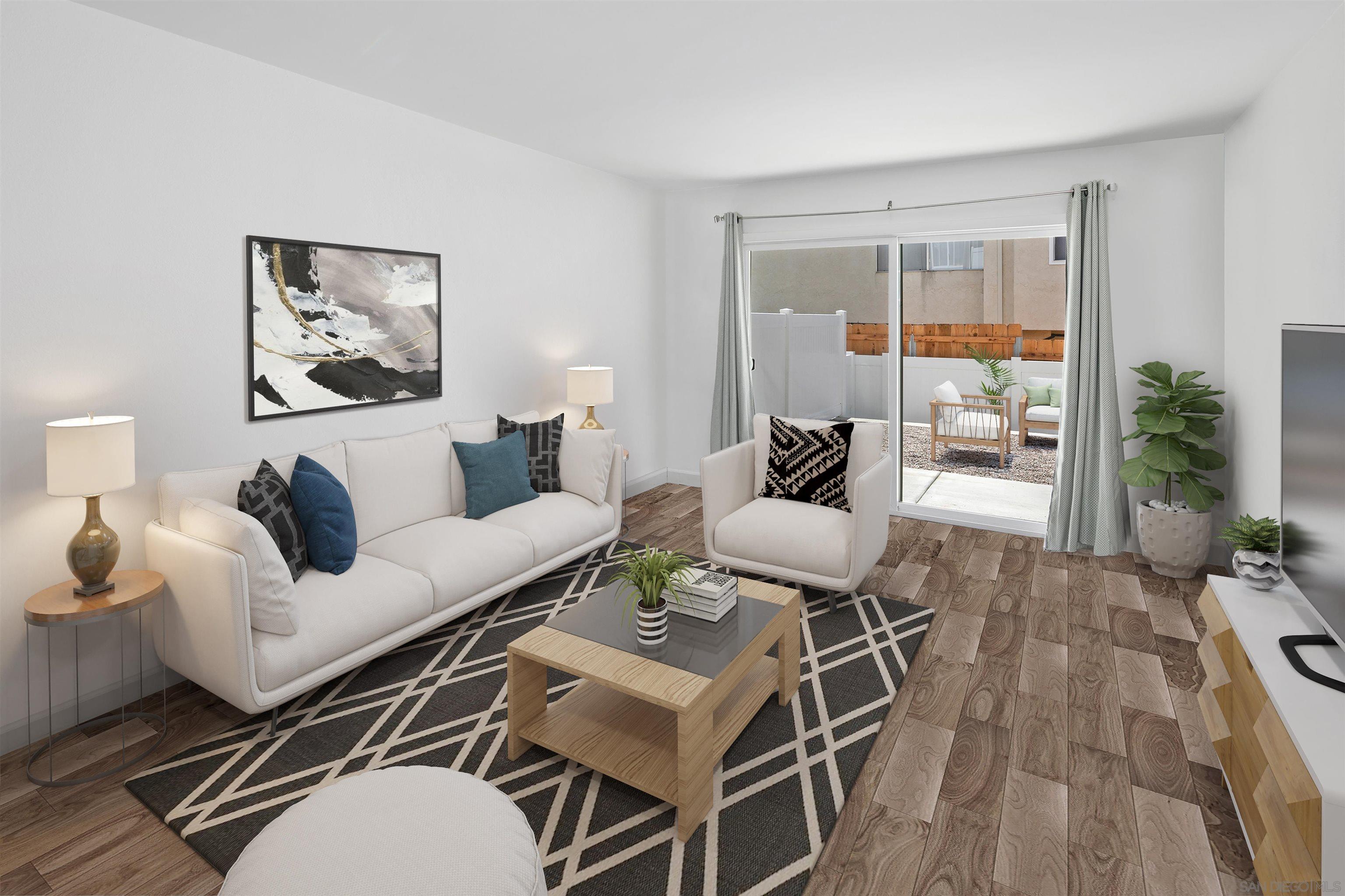 a living room with furniture and wooden floor