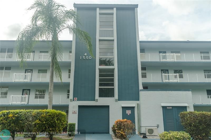 a front view of a building with a garden