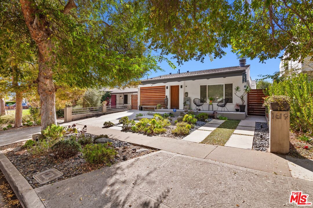 a front view of a house with garden and patio