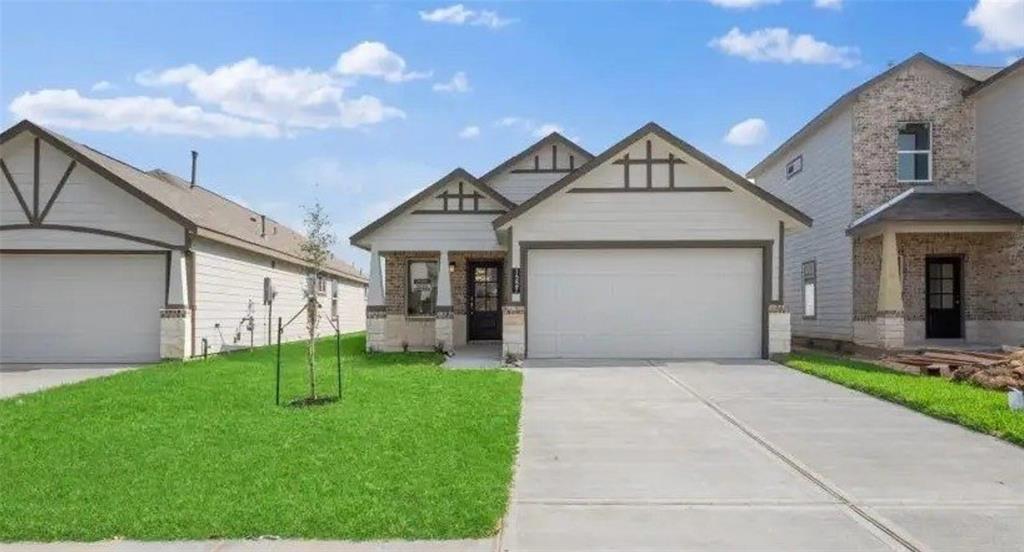 a view of a house with a yard and pathway