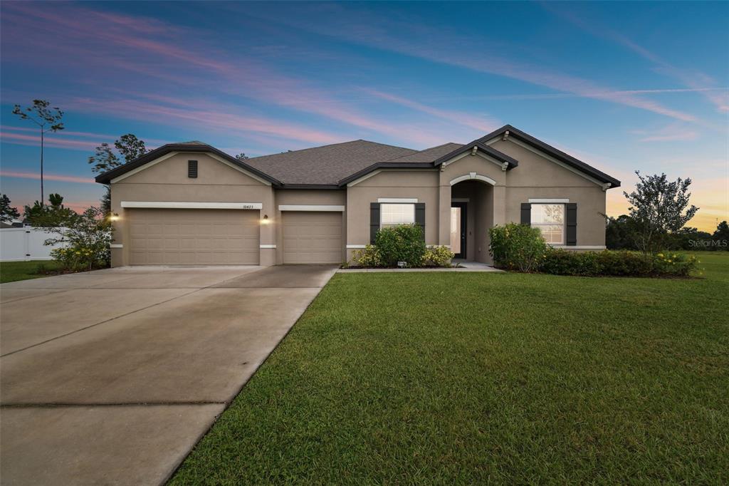 a front view of a house with a yard and garage