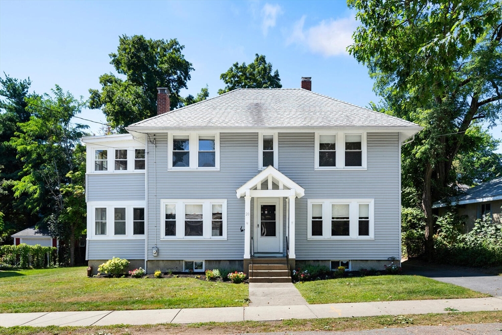 a front view of a house with a yard