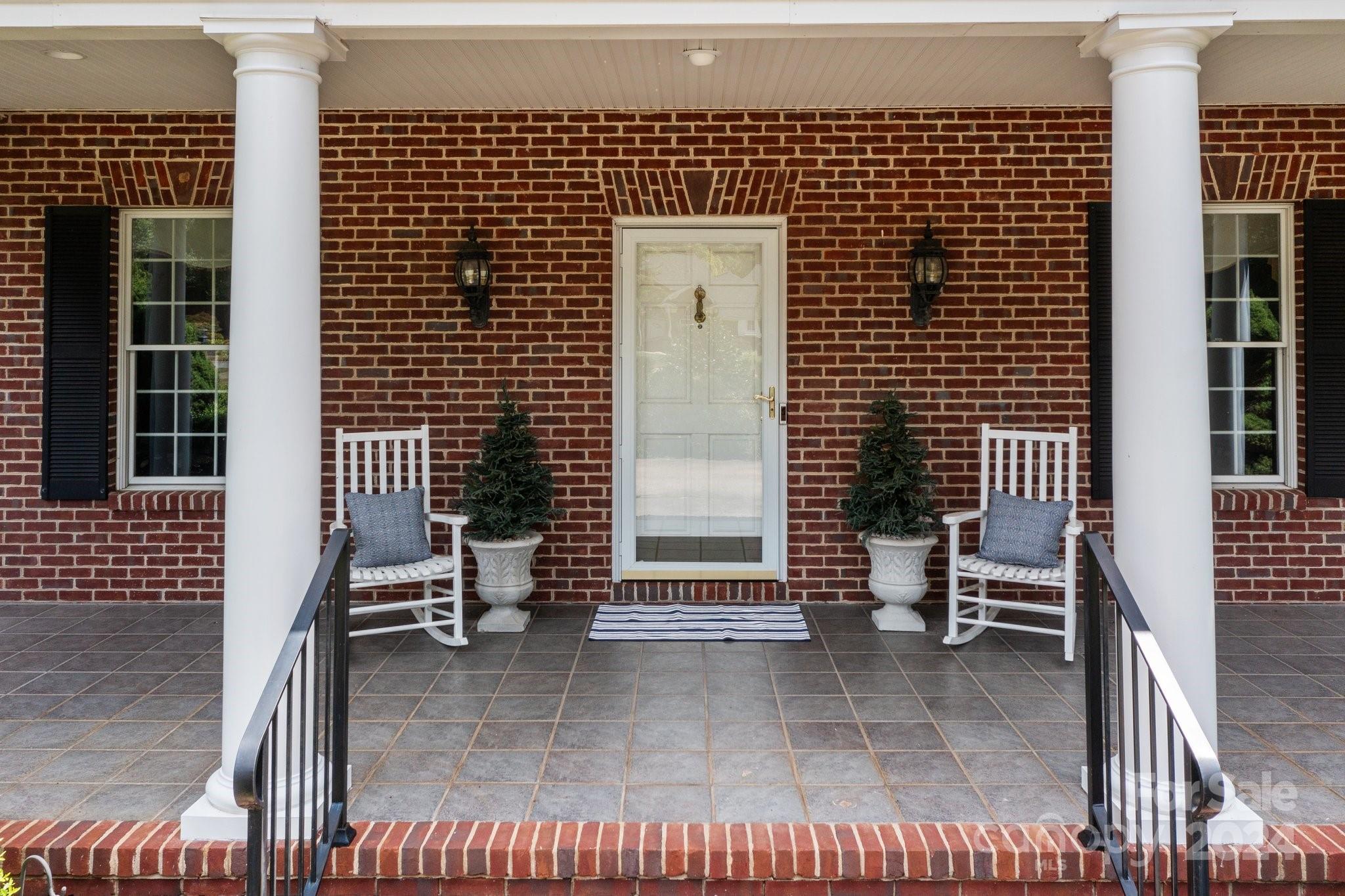 a view of a patio with a table and chairs