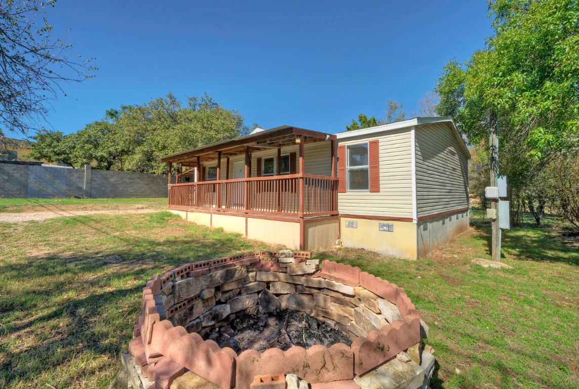 a view of a house with backyard and sitting area