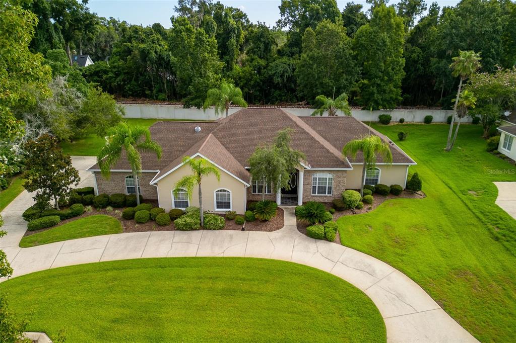 a front view of house with yard and green space