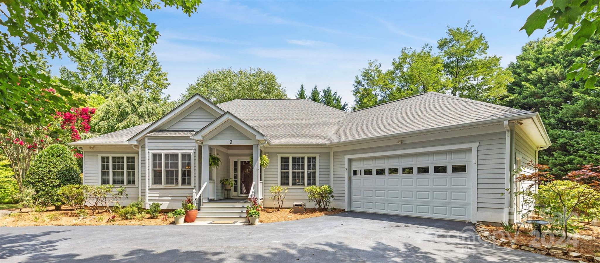 a front view of a house with a garden