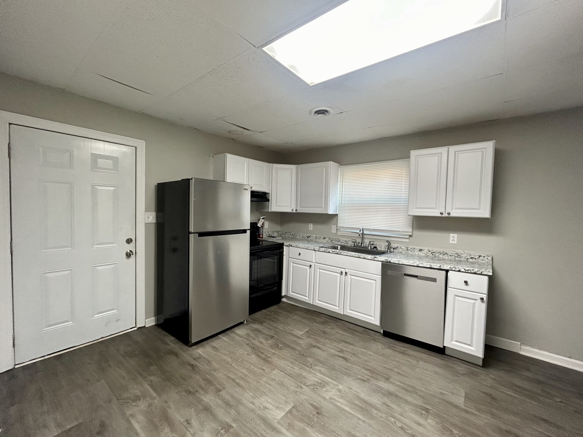 a kitchen with stainless steel appliances granite countertop a refrigerator oven a sink and dishwasher