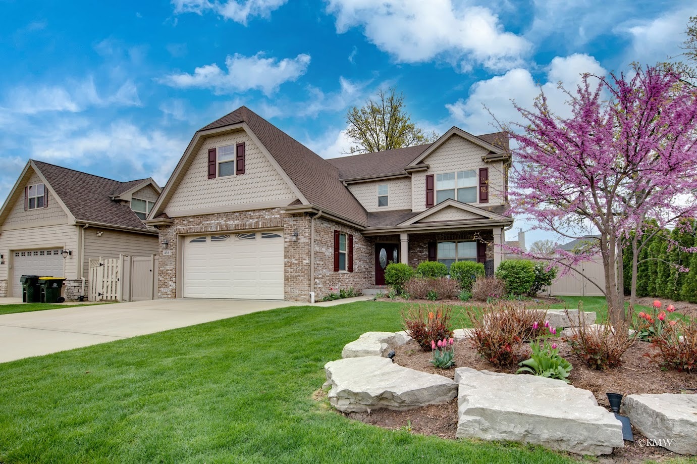 a front view of a house with a yard and garage