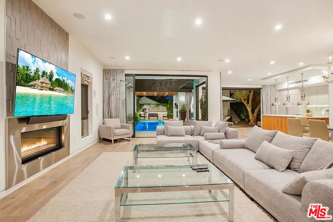 a living room with furniture fireplace and a flat screen tv