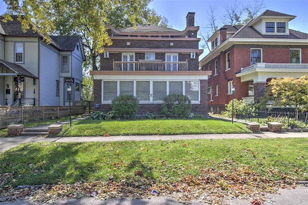 a front view of house with yard and green space