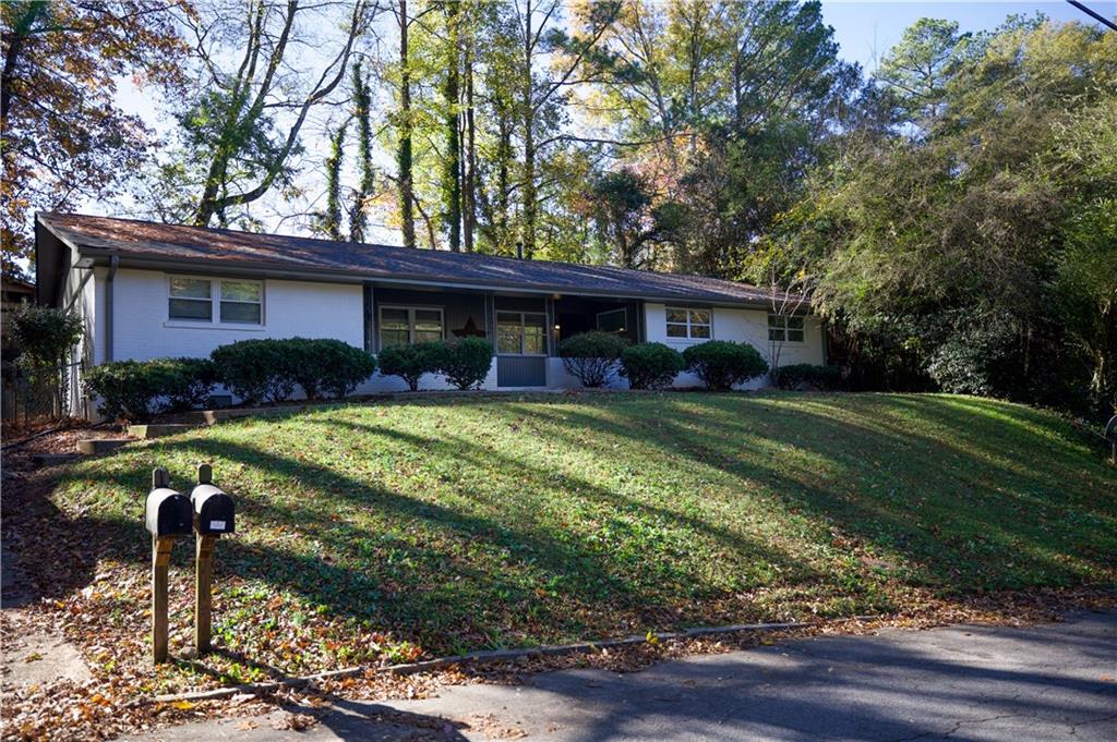 a view of house with yard and outdoor seating