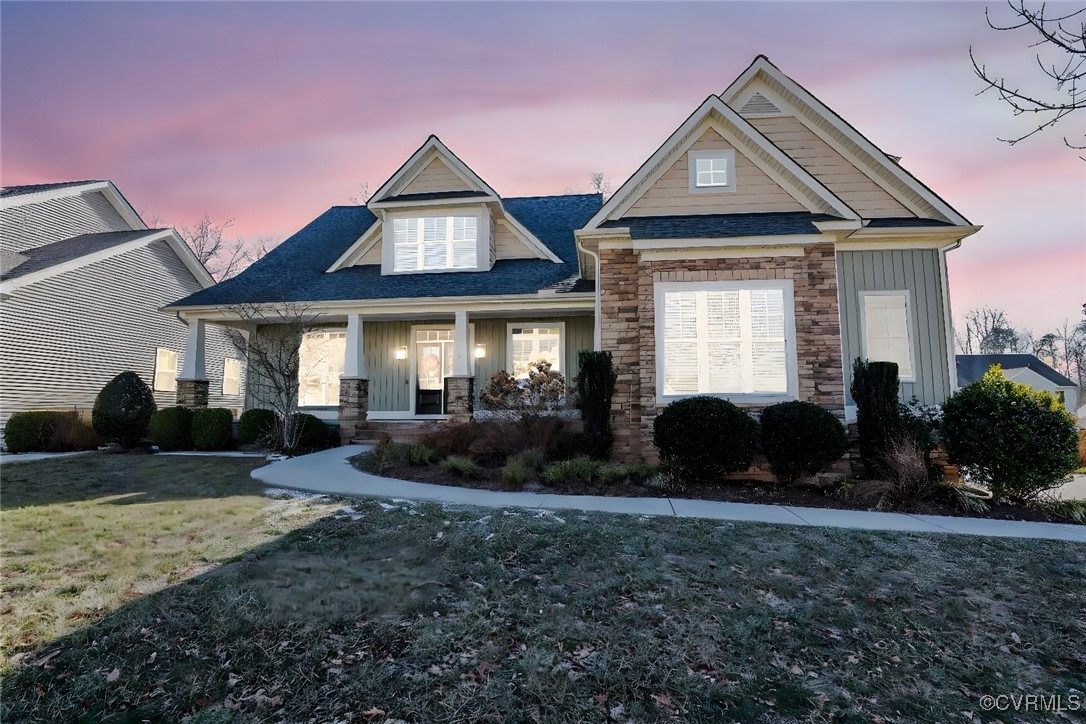 View of front of house featuring covered porch and