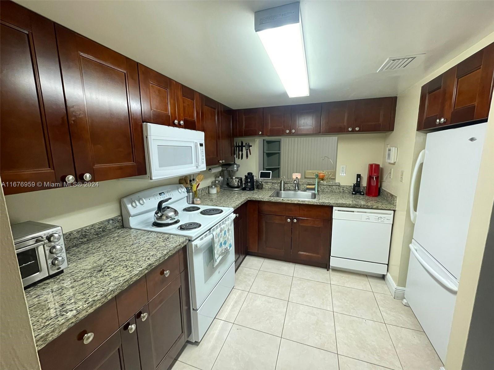 a kitchen with a sink stove and refrigerator