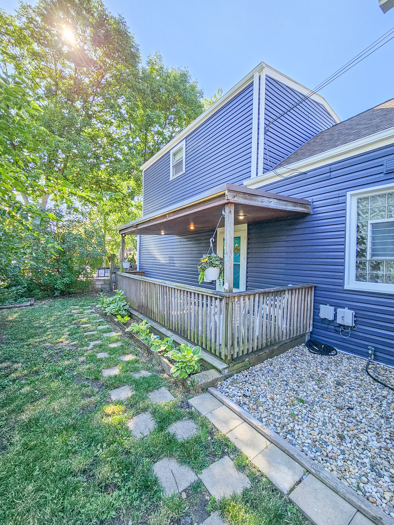 a view of a house with a small yard and wooden fence