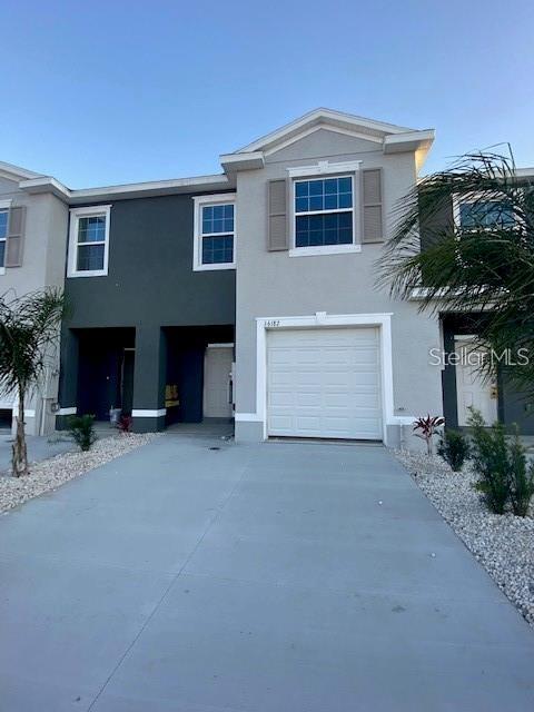 a front view of a house with a yard and garage