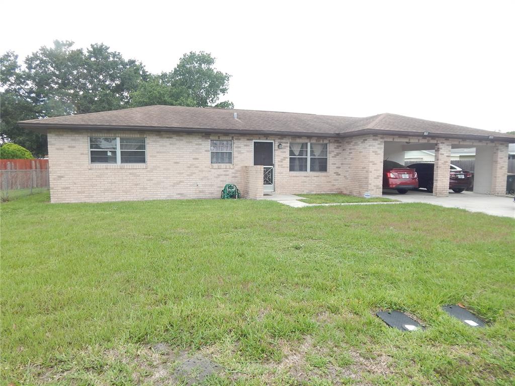 a view of a house with a yard and a garage