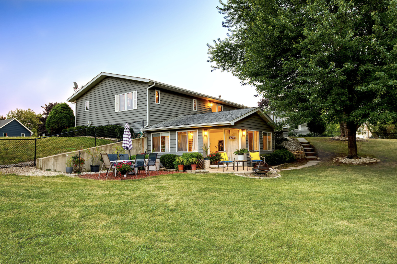 a view of a house with backyard and sitting area