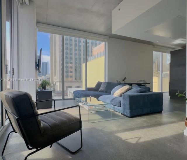 a living room with furniture and a large window