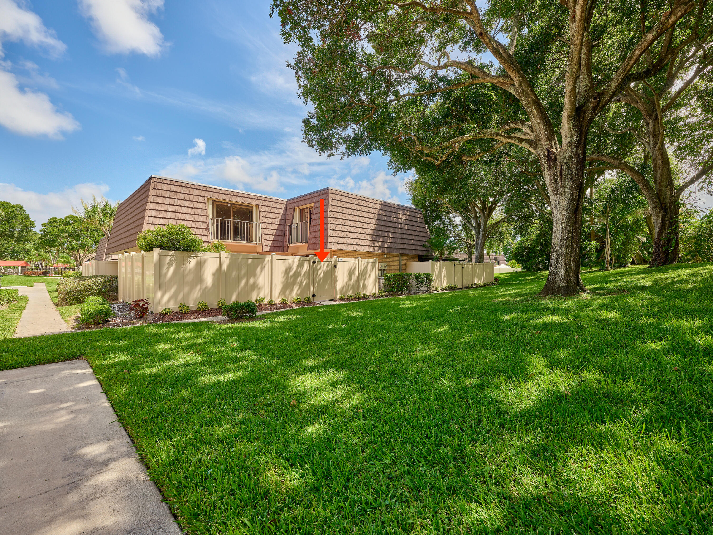 a front view of a house with a yard and trees